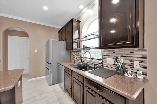 kitchen with backsplash, dark brown cabinetry, ornamental molding, and a sink