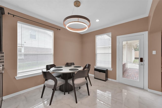 dining room featuring an inviting chandelier, baseboards, marble finish floor, and a wealth of natural light