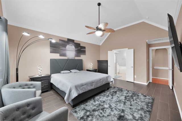 bedroom featuring wood tiled floor, crown molding, baseboards, lofted ceiling, and ensuite bathroom