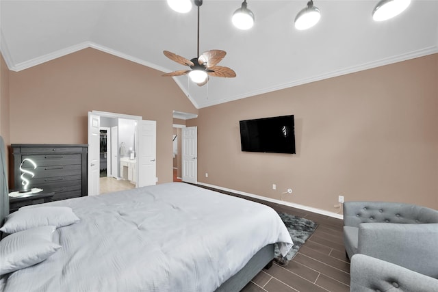 bedroom featuring ornamental molding, wood finished floors, baseboards, ensuite bathroom, and vaulted ceiling