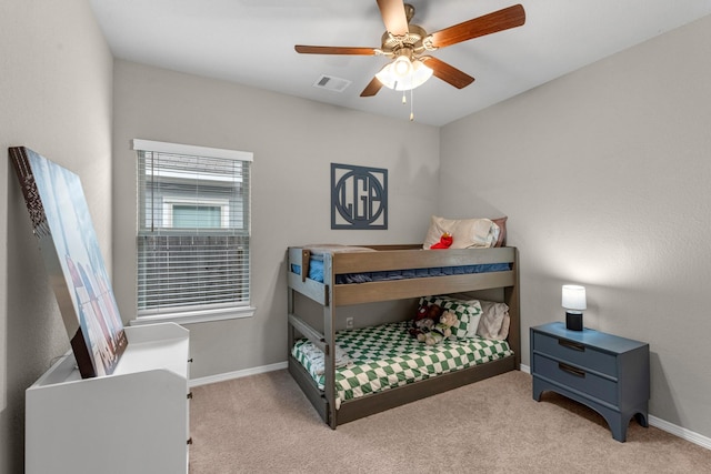 bedroom with baseboards, ceiling fan, visible vents, and light colored carpet