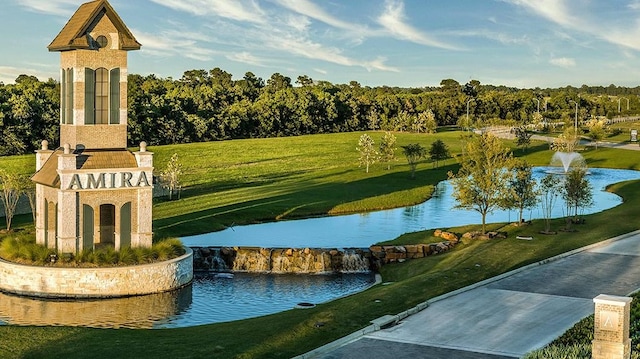 view of community featuring a water view and a yard