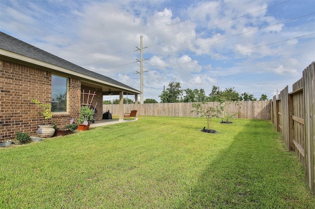 view of yard featuring a patio area and a fenced backyard