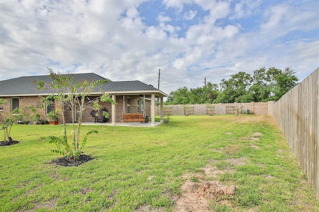 view of yard featuring a patio area and a fenced backyard