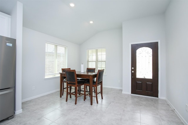 dining area with lofted ceiling, light tile patterned floors, recessed lighting, and baseboards