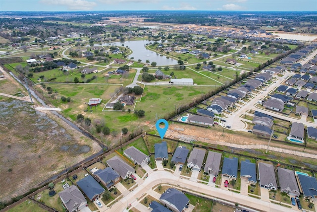 drone / aerial view featuring a residential view and a water view