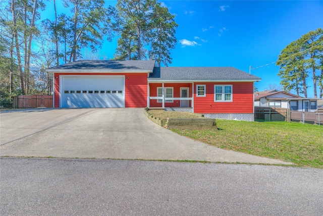 view of front of home with a garage, concrete driveway, a front lawn, and fence