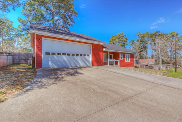 ranch-style house with a garage, concrete driveway, and fence