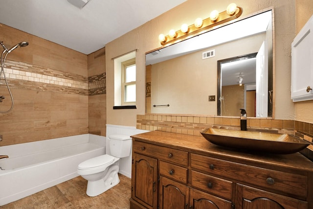 4900 Sandalwood Cir, Baytown, TX 77521 - full bath with toilet, wood finished floors, vanity, visible vents, and washtub / shower combination