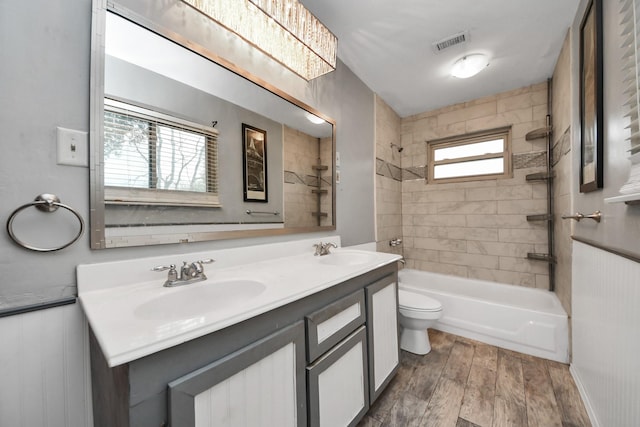 4900 Sandalwood Cir, Baytown, TX 77521 - bathroom featuring wood finished floors, bathing tub / shower combination, a sink, and visible vents