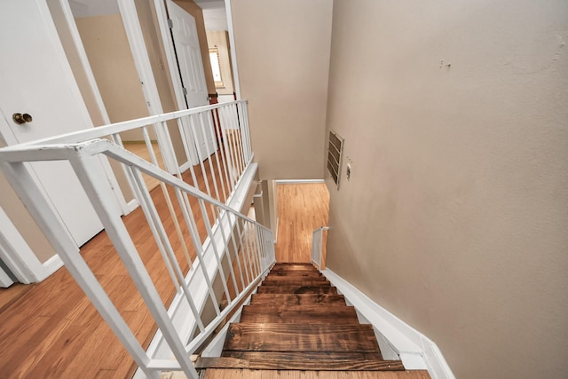 4900 Sandalwood Cir, Baytown, TX 77521 - staircase with visible vents, baseboards, and wood finished floors