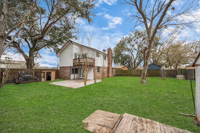4900 Sandalwood Cir, Baytown, TX 77521 - back of property with a patio area, a chimney, brick siding, and a yard