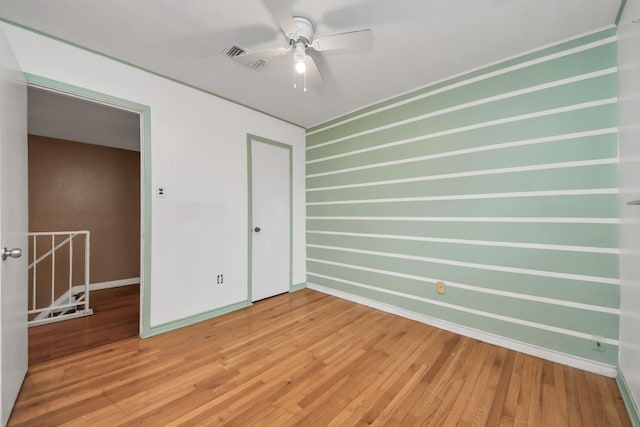 4900 Sandalwood Cir, Baytown, TX 77521 - unfurnished room with ceiling fan, baseboards, and wood finished floors