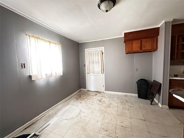 interior space featuring light floors and baseboards