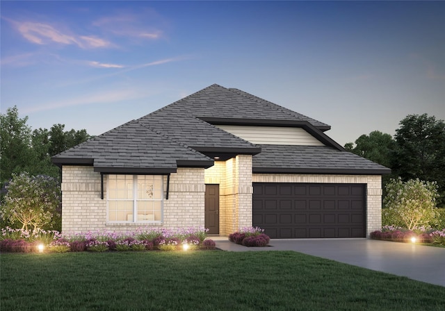 view of front of home with driveway, a shingled roof, a front lawn, and brick siding