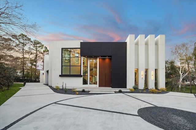 exterior space with concrete driveway and stucco siding