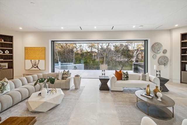 living area with built in shelves and recessed lighting