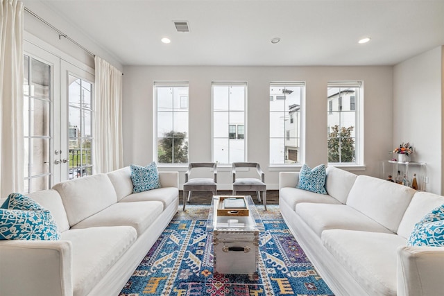 living area with a healthy amount of sunlight, visible vents, and recessed lighting