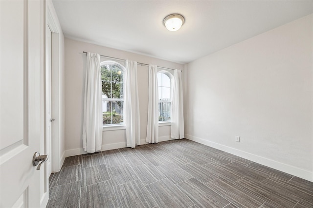 unfurnished room featuring baseboards