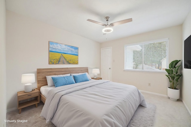 bedroom with baseboards, a ceiling fan, and light colored carpet