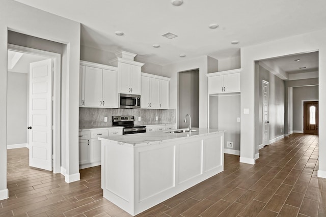 kitchen featuring visible vents, white cabinets, wood tiled floor, stainless steel appliances, and a sink