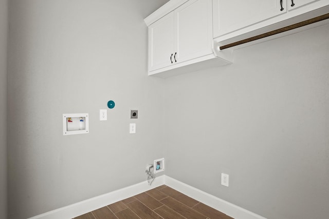 laundry room with cabinet space, baseboards, hookup for a washing machine, wood finish floors, and electric dryer hookup