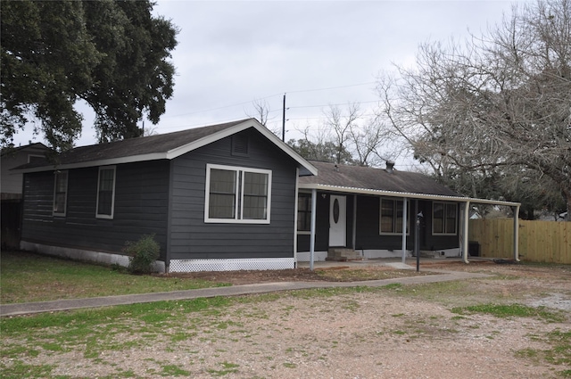 ranch-style house featuring covered porch and fence