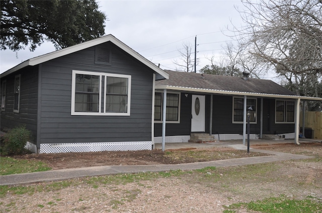 view of front facade featuring a shingled roof, entry steps, and covered porch