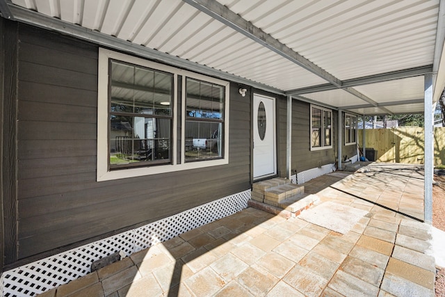 property entrance with a patio area and fence