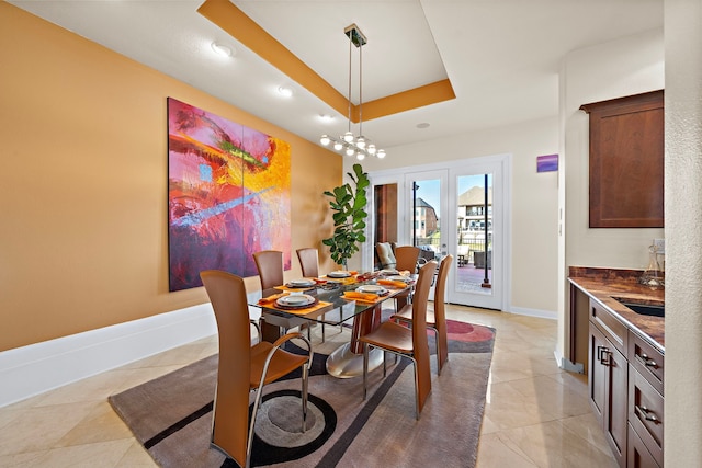 dining space featuring light tile patterned floors, baseboards, a raised ceiling, and recessed lighting