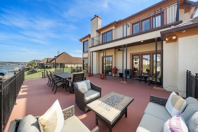 10804 Bourbon St, Willis, TX 77318 - view of patio / terrace featuring a balcony, an outdoor living space, french doors, a ceiling fan, and outdoor dining area