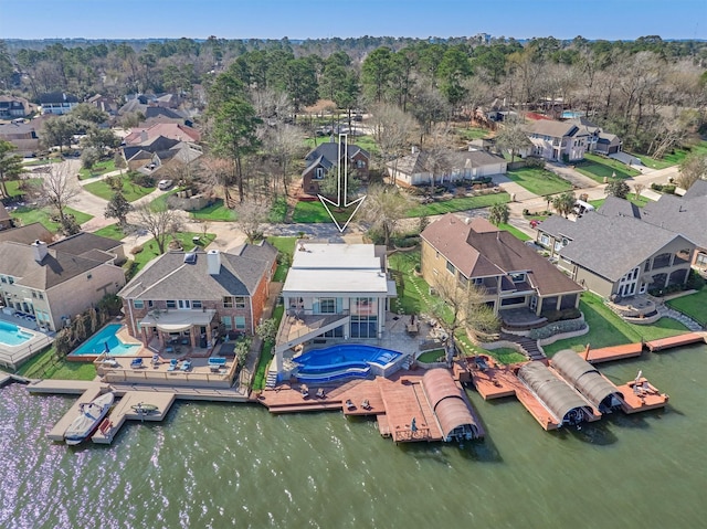 birds eye view of property featuring a water view and a residential view