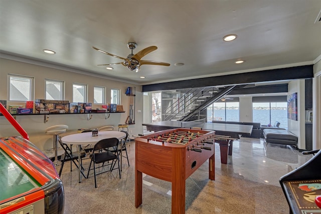 recreation room with a water view, ceiling fan, a wealth of natural light, and recessed lighting