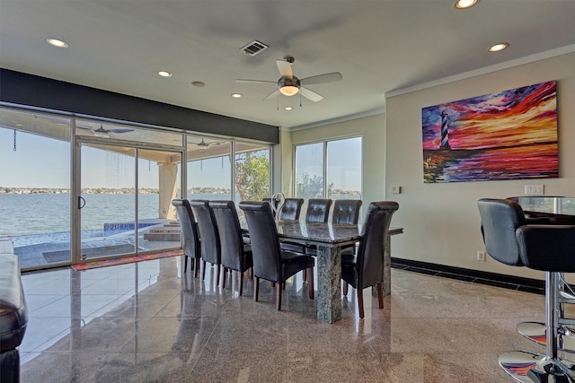 dining area with recessed lighting, a water view, granite finish floor, visible vents, and baseboards