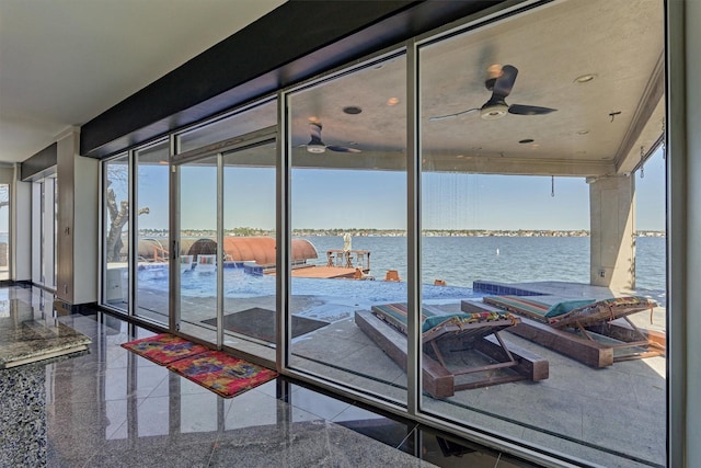 interior space featuring a water view and ceiling fan