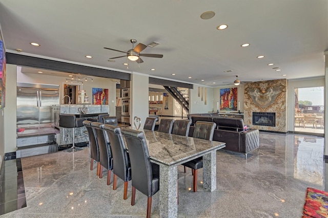 dining space featuring a large fireplace, marble finish floor, visible vents, and recessed lighting