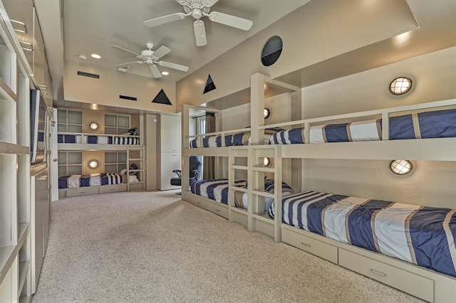 carpeted bedroom featuring high vaulted ceiling and a ceiling fan