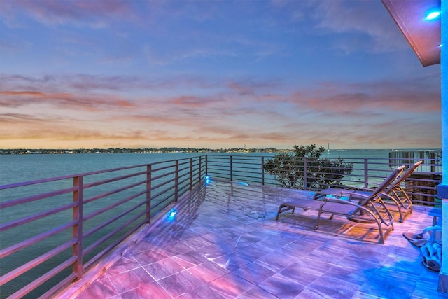 patio terrace at dusk with a water view