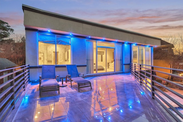 view of patio terrace at dusk