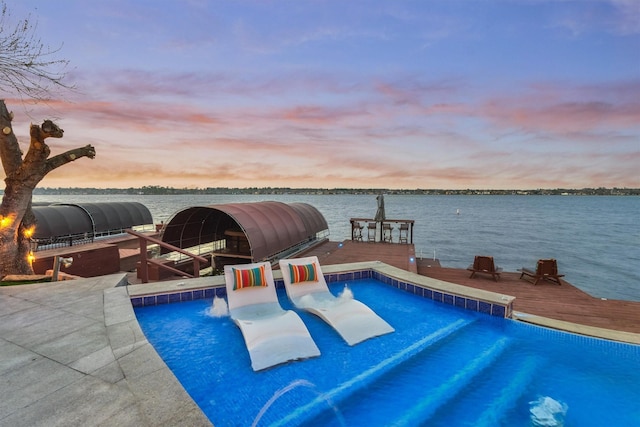 pool at dusk with a water view