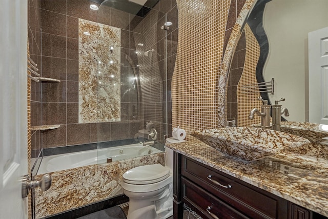 bathroom featuring a combined bath / shower with marble appearance, vanity, and toilet