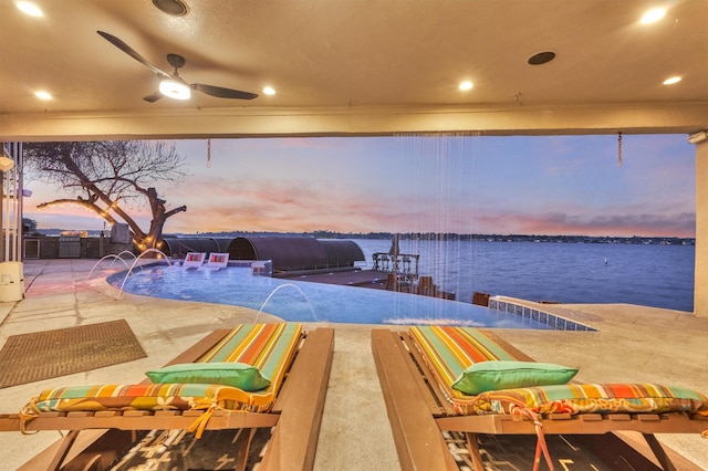 dock area with a patio area and a water view