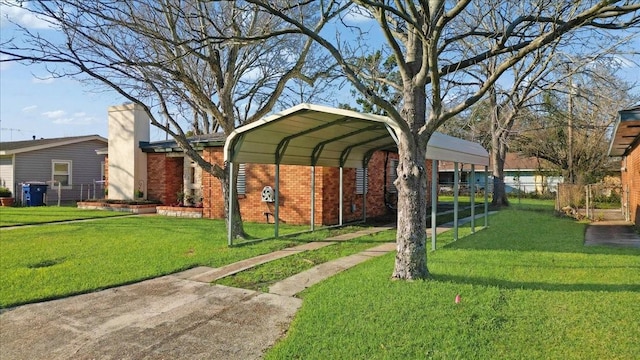 view of yard with fence and a detached carport