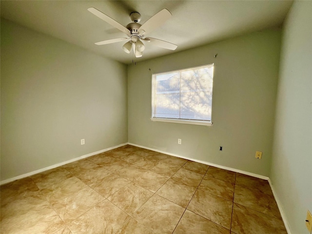 empty room with baseboards, a ceiling fan, and light tile patterned flooring