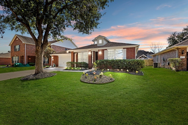 view of front of house featuring brick siding, concrete driveway, a garage, cooling unit, and a front lawn