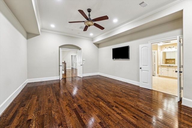 unfurnished living room with dark wood-style floors, arched walkways, crown molding, visible vents, and ceiling fan