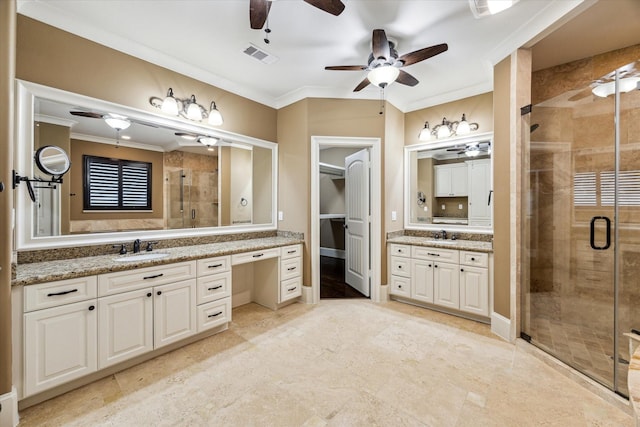 bathroom featuring visible vents, two vanities, ornamental molding, a stall shower, and a sink