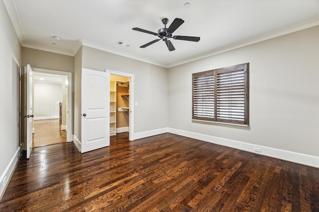 unfurnished bedroom with baseboards, dark wood finished floors, visible vents, and crown molding