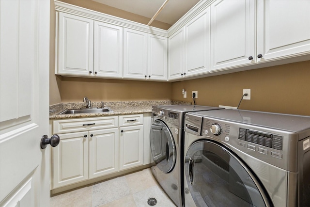 washroom with independent washer and dryer, cabinet space, a sink, and light tile patterned floors