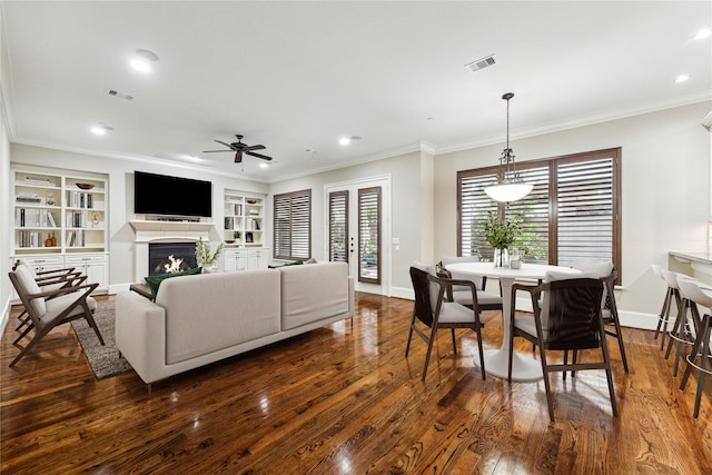 living room with ornamental molding, dark wood-style flooring, and visible vents